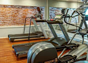 Thumbnail 13 of 101 - the gym has a large screen tv and a treadmill