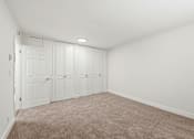 Thumbnail 131 of 133 - A room with white walls and a carpeted floor.