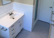 Thumbnail 25 of 31 - an empty bathroom with a sink and a shower