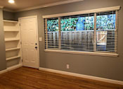 Thumbnail 41 of 47 - A room with a white door and a window with blinds.