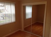 Thumbnail 15 of 22 - A room with a sliding door and a window with blinds.
