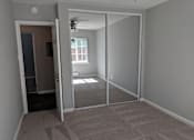 Thumbnail 19 of 63 - A room with a carpeted floor and a ceiling fan.