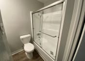 Thumbnail 31 of 51 - a small bathroom with a toilet and a shower