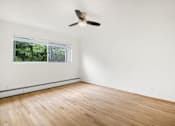 Thumbnail 31 of 33 - A room with a ceiling fan and a window.