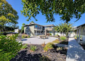 Thumbnail 10 of 50 - A sunny day at a residential area with a house and a garden.