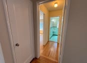 Thumbnail 12 of 19 - a bedroom and a hallway with a door open to a bathroom