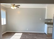 Thumbnail 19 of 37 - A room with a ceiling fan and wooden flooring.