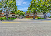 Thumbnail 29 of 41 - A street view of a residential area with houses and trees.