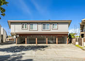 Thumbnail 23 of 42 - A modern house with a grey facade and a garage.