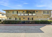 Thumbnail 18 of 33 - A two-story apartment building with a balcony on the second floor.