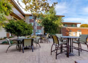Thumbnail 30 of 37 - an outdoor patio with tables and chairs and trees