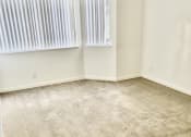 Thumbnail 2 of 26 - an empty room with two windows and a carpeted floor
