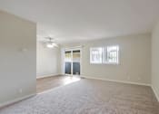 Thumbnail 20 of 37 - A spacious room with a carpeted floor and a ceiling fan.