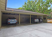 Thumbnail 7 of 47 - A carport with three cars parked inside.