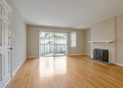Thumbnail 17 of 37 - A room with a fireplace and wooden floors.
