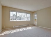 Thumbnail 25 of 33 - a room of an empty apartment with a large window