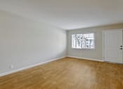 Thumbnail 10 of 38 - A room with wooden flooring and a white door.