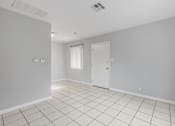 Thumbnail 34 of 38 - A room with white walls and a tiled floor.