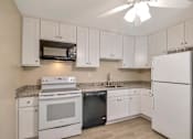 Thumbnail 2 of 13 - a white kitchen with white appliances and white cabinets