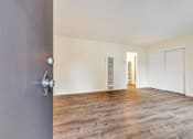 Thumbnail 41 of 43 - A room with a grey door and wooden flooring.