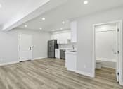 Thumbnail 44 of 60 - A kitchen with white cabinets and a refrigerator.