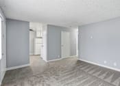 Thumbnail 27 of 55 - A spacious room with a carpeted floor and a few doors.