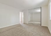 Thumbnail 37 of 52 - A room with a carpeted floor and a glass door.