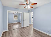Thumbnail 12 of 17 - A room with a ceiling fan and a sliding glass door.