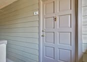 Thumbnail 13 of 34 - A white door with a keyhole is on the right side of a wall with horizontal siding.