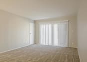 Thumbnail 20 of 29 - the living room of an apartment with a large window with white blinds