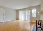 Thumbnail 33 of 37 - A room with wooden floors and a white door.