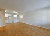 Thumbnail 11 of 38 - A room with wooden flooring and white walls.