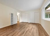Thumbnail 36 of 43 - A room with wooden flooring and white walls.