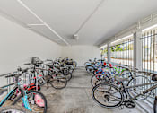 Thumbnail 19 of 43 - A bike rack full of bicycles in a white room.