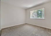 Thumbnail 39 of 52 - A room with a window covered by blinds.