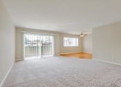 Thumbnail 27 of 37 - A spacious room with a carpeted floor and a ceiling fan.