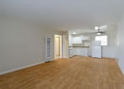 Thumbnail 12 of 38 - A room with wooden flooring and a ceiling fan.