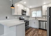 Thumbnail 10 of 53 - a kitchen with white cabinets and stainless steel appliances