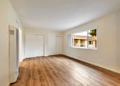 Thumbnail 25 of 43 - A room with wooden floors and white walls.