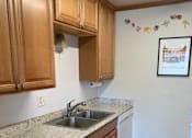 Thumbnail 5 of 32 - a kitchen with a stainless steel sink and wooden cabinets