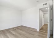 Thumbnail 61 of 92 - A room with light wood flooring and white walls.
