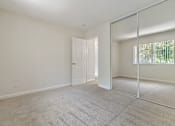 Thumbnail 41 of 52 - A room with a carpeted floor and a white door.