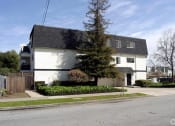 Thumbnail 5 of 15 - a white house with a gray roof on a street