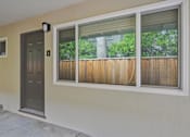 Thumbnail 4 of 47 - A brown wooden fence is seen through a window.