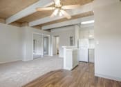 Thumbnail 22 of 32 - A kitchen with white appliances and wooden floors.