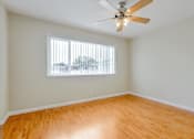 Thumbnail 26 of 37 - A room with a ceiling fan and a window with blinds.