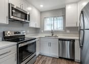 Thumbnail 28 of 53 - a kitchen with white cabinets and stainless steel appliances