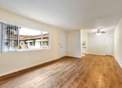 Thumbnail 39 of 43 - A room with wooden floors and white walls.