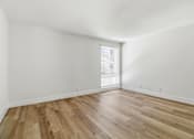 Thumbnail 42 of 92 - A room with wooden flooring and a window with blinds.