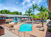 Thumbnail 16 of 25 - A swimming pool surrounded by a fence and chairs.
